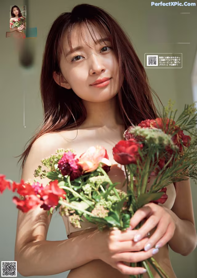 A woman holding a bunch of flowers in her hands.