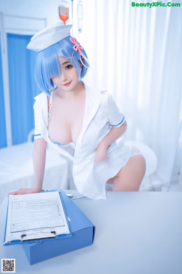 A woman in a white nurse outfit sitting at a table.