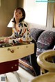 A woman sitting at a table playing a game of foo foo.