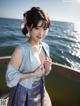 A woman in a blue kimono posing for a picture by the water.