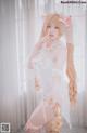 A woman in a white dress and pink stockings posing for a picture.