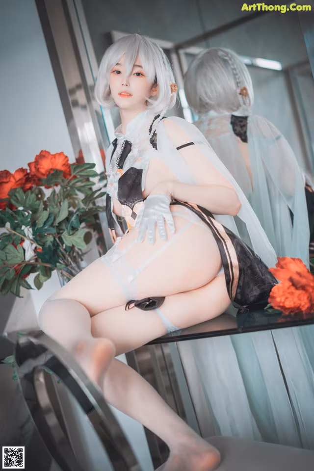 A woman sitting on top of a table next to a mirror.