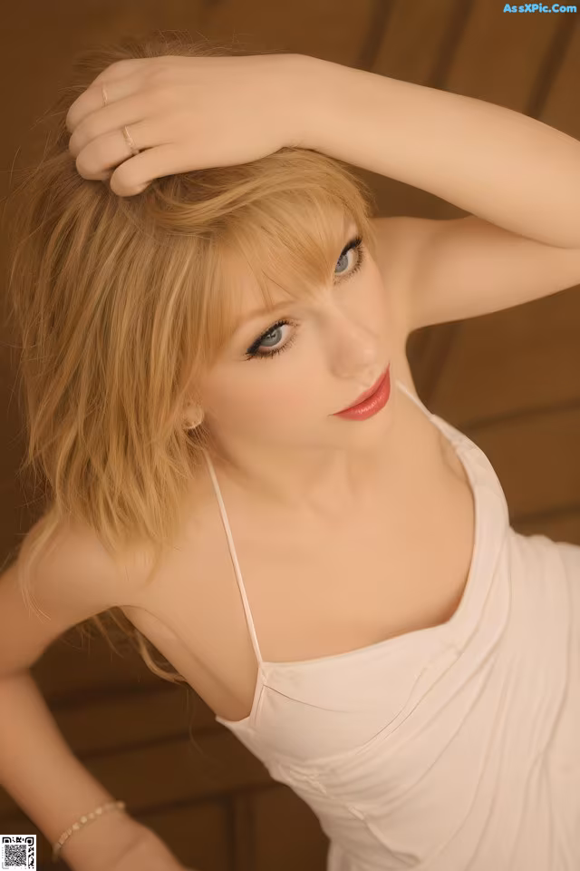 A woman in a white dress posing for a picture.
