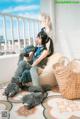 A woman sitting on a bean bag chair with a stuffed animal.