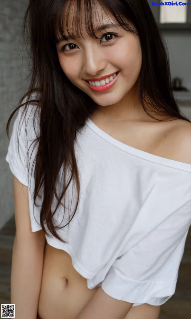A woman in a white shirt is posing for a picture.
