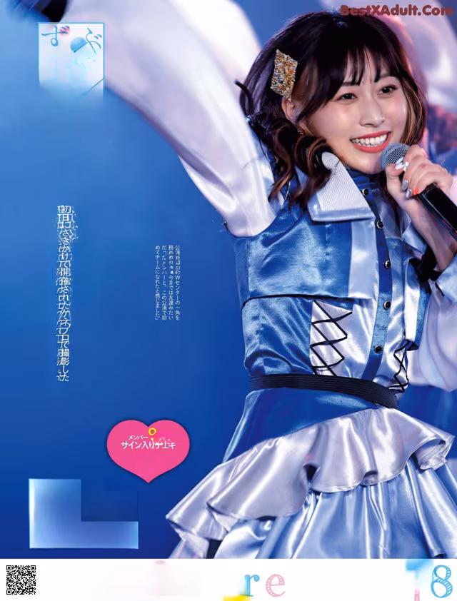 A woman in a blue dress holding a microphone.